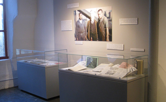 Art gallery with archival materials in glass case